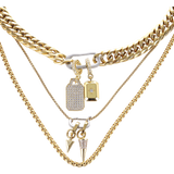The Just Click Tag Necklace Set, a four-piece gold necklace set featuring a Cuban link chain, a box chain, and a rope chain with diamond-like accents, two dog tag charms, and a spike charm.