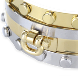 This gold and silver-toned Herradura Armor Bracelet Stack includes three bangles, one with the signature Artizan horseshoe design and a secure clasp closure and two dot bangles in gold and silver.