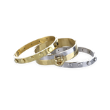 This gold and silver-toned Herradura Armor Bracelet Stack includes three bangles, one with the signature Artizan horseshoe design and a secure clasp closure and two dot bangles in gold and silver.