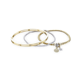 The Golden Gear Bracelet Stack, a three-piece gold bracelet stack featuring a bangle with diamond-like accents, a diamond-like tennis bracelet, and a chain bracelet with two charms.