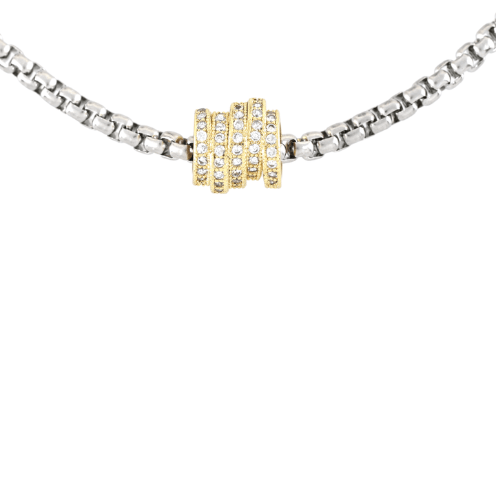 The Nut Necklace, a silver box chain with a gold nut-shaped pendant encrusted with stones. ||| MIX