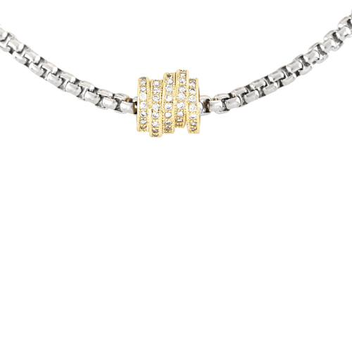 The Nut Necklace, a silver box chain with a gold nut-shaped pendant encrusted with stones. ||| MIX