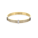The MARINERO BANGLE, which is a single gold-tone bracelet, features sleek, parallel silver wires along its top surface, creating a refined two-tone nautical-inspired design. This elegant piece by Artizan adds a sophisticated touch with its polished finish and sturdy construction, ideal for daily wear or special occasions. ||| GOLD