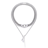 The Needle and the Tennis Necklace Set, a three-piece silver necklace set featuring two chains, a diamond-like tennis necklace, and a dangling spike charm.


