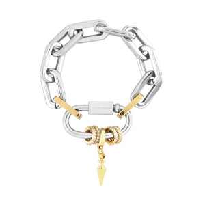 The CARABINER PAVE PUERTO BRACELET featuring a silver chunky chain link design and a silver carabiner clasp. The bracelet includes a stack of delicate gold rings adorned with sparkling diamonds and a gold spike link charm. 