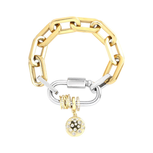 The CARABINER DOTS PUERTO BRACELET featuring a chunky chain link design and a silver carabiner clasp. The bracelet includes a stack of delicate gold rings and the DALMATIAN BULKY CHARM with sparkling diamonds.