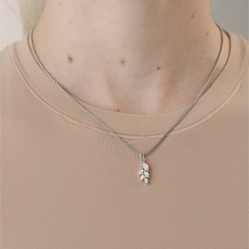 Model wearing the LEAVES ZIRCONIA NECKLACE which is made of 1mm wide Stainless steel chain with 18K gold plated sterling silver Leaves zirconia charm.