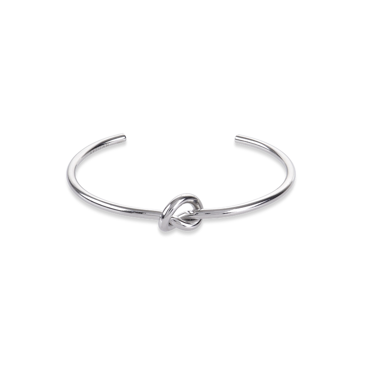 The KNOT, a single elegant silver open cuff bracelet featuring a stylish knot detail at the center, designed for a minimalist and refined look ||| SILVER