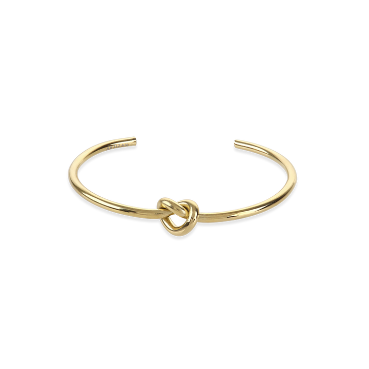 The KNOT, a single elegant gold open cuff bracelet featuring a distinctive knot detail at the center, crafted for a minimalist and sophisticated look ||| GOLD