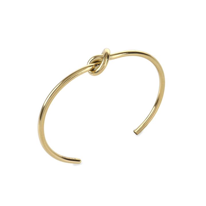 The KNOT, a single elegant gold open cuff bracelet featuring a distinctive knot detail at the center, crafted for a minimalist and sophisticated look ||| GOLD