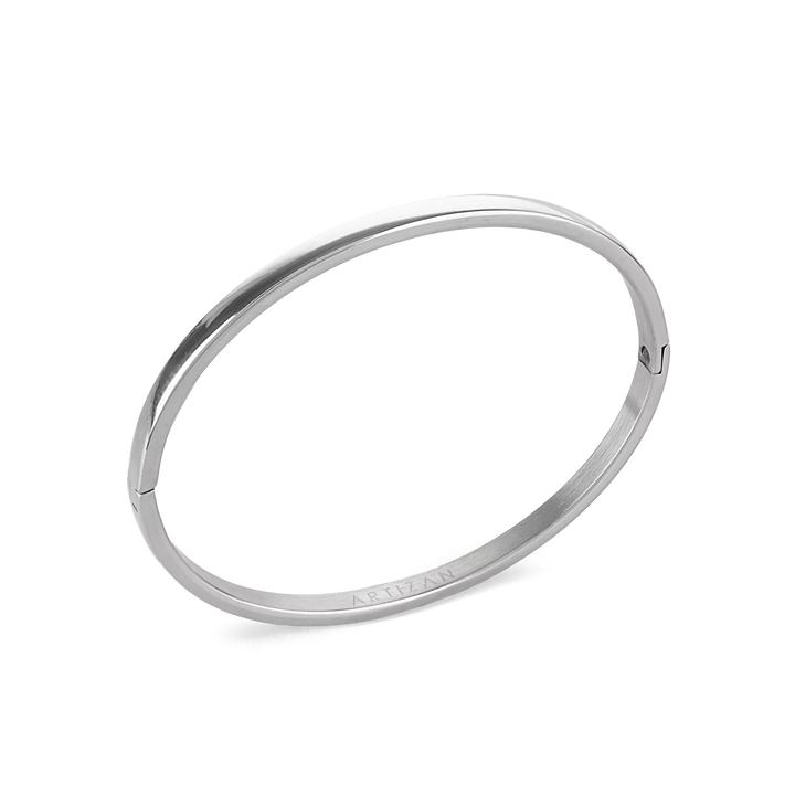 The Plain Bangle, which is a single-piece silver bangle, features a sleek and polished finish, offering a minimalist and timeless design perfect for everyday wear or stacking with other bracelets for a modern, chic look. ||| SILVER