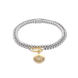 The Tennis and the Box Bracelet Set, a two-piece silver bracelet set featuring a diamond-like tennis bracelet and a box chain bracelet with a gold north star charm accented with diamond-like stones.