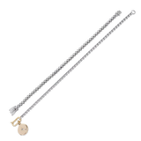 The Tennis and the Box Bracelet Set, a two-piece silver bracelet set featuring a diamond-like tennis bracelet and a box chain bracelet with a gold north star charm accented with diamond-like stones.