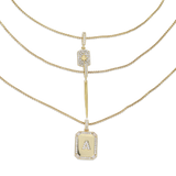 The You and the Needle Necklace Set, a three-piece gold necklace set with a needle pendant and initial charm.
