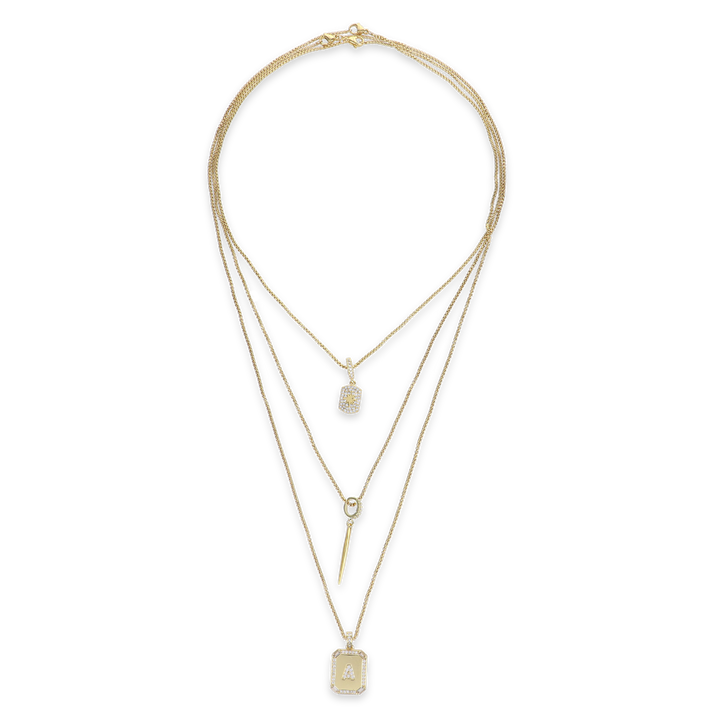 The You and the Needle Necklace Set, a three-piece gold necklace set with a needle pendant and initial charm.