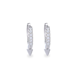 The MINI SHOT HOOP, which is a pair of sleek silver earrings, features a delicate hoop design adorned with sparkling cubic zirconia stones and finished with a pointed charm at the base for a modern edge. Perfect for adding a subtle yet bold statement to any outfit.
