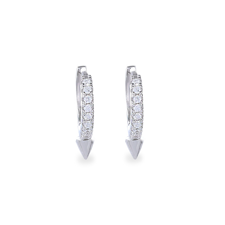 The MINI SHOT HOOP, which is a pair of sleek silver earrings, features a delicate hoop design adorned with sparkling cubic zirconia stones and finished with a pointed charm at the base for a modern edge. Perfect for adding a subtle yet bold statement to any outfit.