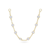 The Endless Diamond Earring Chain, a gold chain featuring seven bezel-set diamond-like stones.