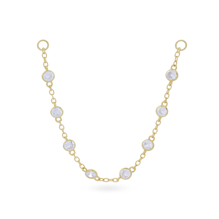 The Endless Diamond Earring Chain, a gold chain featuring seven bezel-set diamond-like stones.