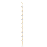 The Endless Diamond Earring Chain, a gold chain featuring seven bezel-set diamond-like stones. She is also earing a tiny lightning stud earring