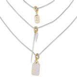 The Tag Needle Necklace Set, a three-piece silver necklace set featuring three chains with two diamond-like encrusted dog tag charms and a spike charm.