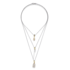 The Tag Needle Necklace Set, a three-piece silver necklace set featuring three chains with two diamond-like encrusted dog tag charms and a spike charm.

