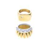 The Madness Ring Stack, a three-piece gold and silver ring stack featuring a gold pinky ring with a single diamond-like stone, a silver ring with diamond-like accents, and a gold ring with a textured geometric design.