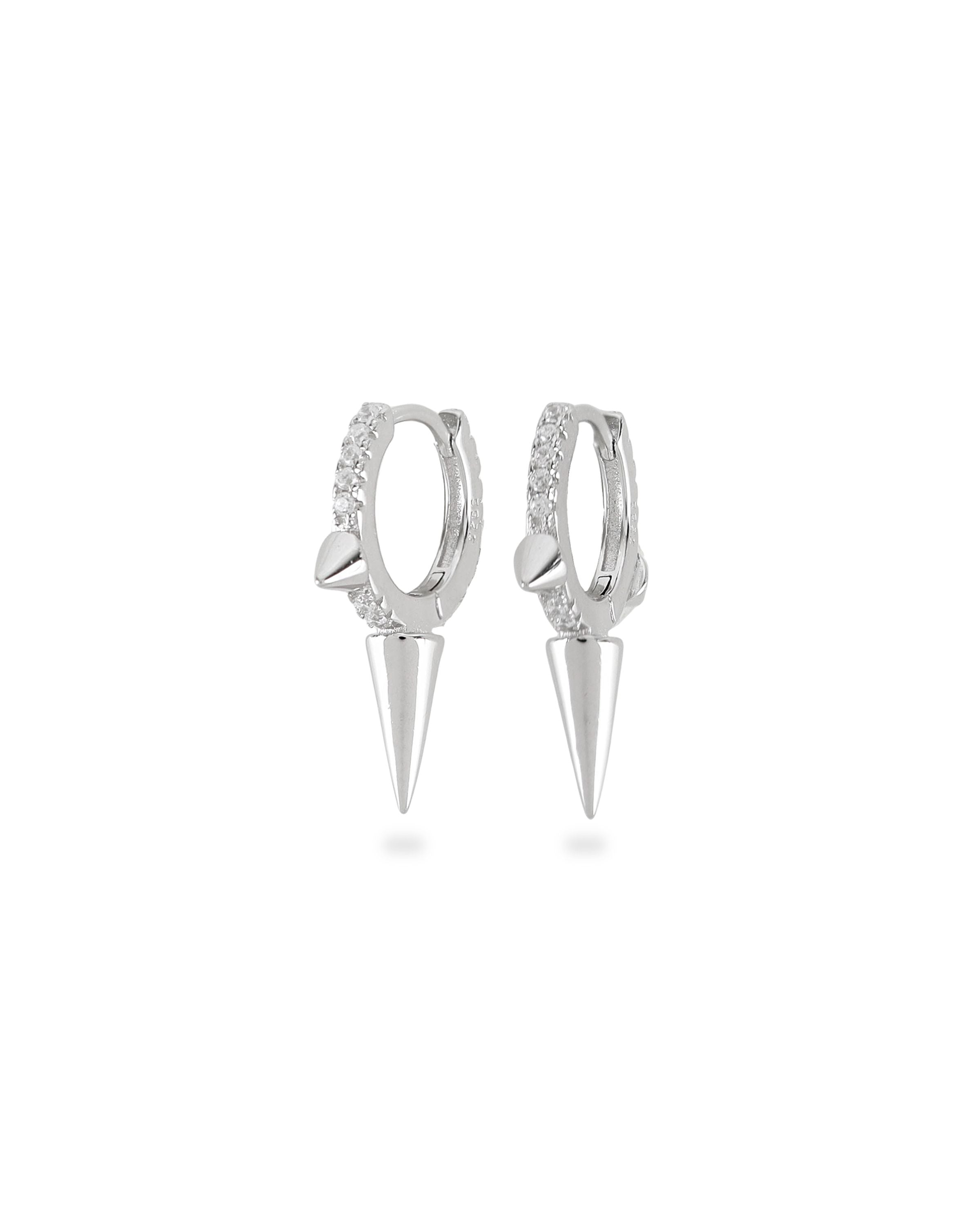 The One Shot Earring, a pair of silver hoop earrings featuring diamond-like accents and spike charms. ||| SILVER