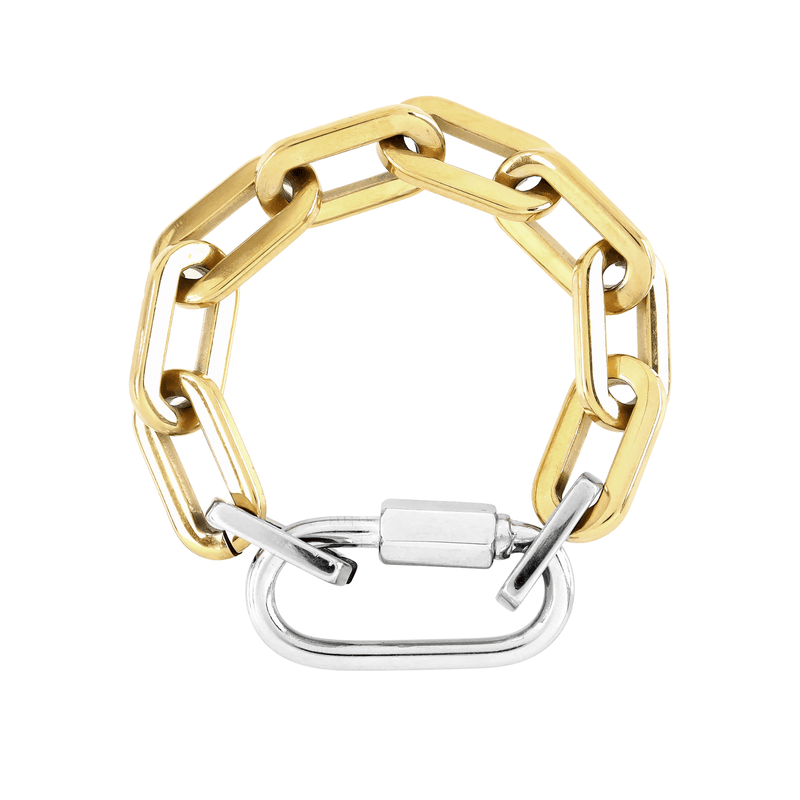 The CARABINER PUERTO BRACELET made of 18k gold plated bulky link chain with silver carabiner. It has two silver links close to the silver carabiner.