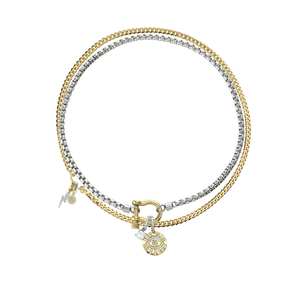 The Herradura Clip On Evil Eye Necklace Set, a two-piece silver and gold necklace set featuring a box chain and a Cuban chain with a gold horseshoe clasp, an evil eye charm, and a lightning bolt charm, all accented with diamond-like stones.
