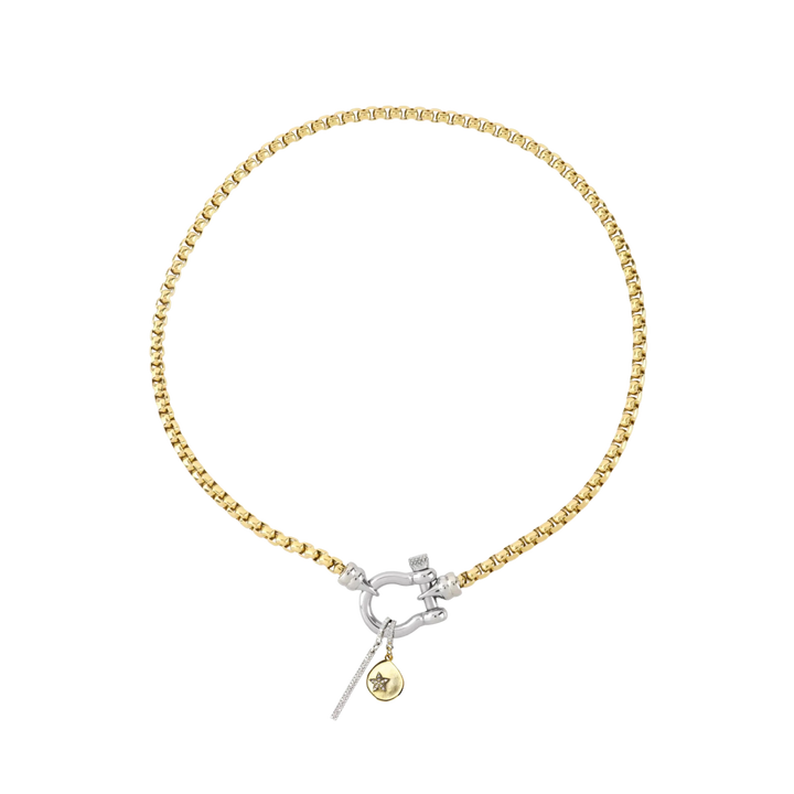 The HERRADURA SIGNATURE DOUBLE TAKE featuring a gold chain with a silver horseshoe clasp and dangling charms, including a pavé bar and a gold star pendant. ||| SILVER