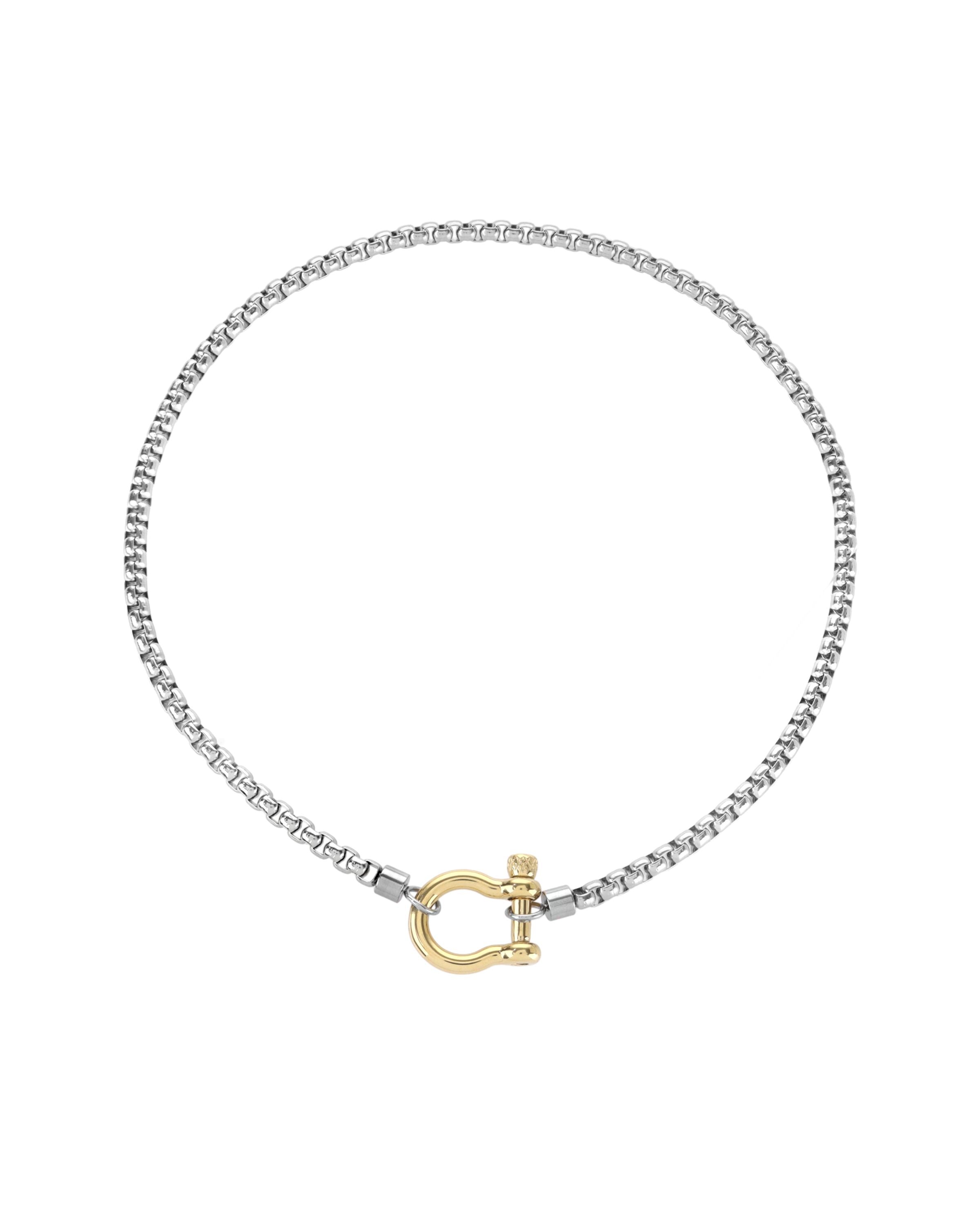 The Herradura Mix Necklace, a silver necklace featuring a box chain with a gold horseshoe clasp. |||Gold