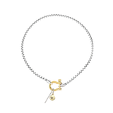 The HERRADURA SIGNATURE DOUBLE TAKE featuring a silver chain with a gold horseshoe clasp and dangling charms, including a pavé bar and a gold star pendant. ||| GOLD