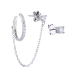 The Ear Cuff with Chain Set, which is a four-pieceThe Ear Cuff with Chain Set, which is a four-piece silver earring set, features a sparkling ear cuff connected by a delicate chain to a stud, accompanied by two additional solitaire studs for versatile styling options and an elegant, contemporary look.
