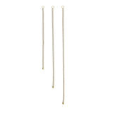 Three pieces of the Tennis Earring Chain, a single long gold chain earring with tiny sparkling stones.||| GOLD