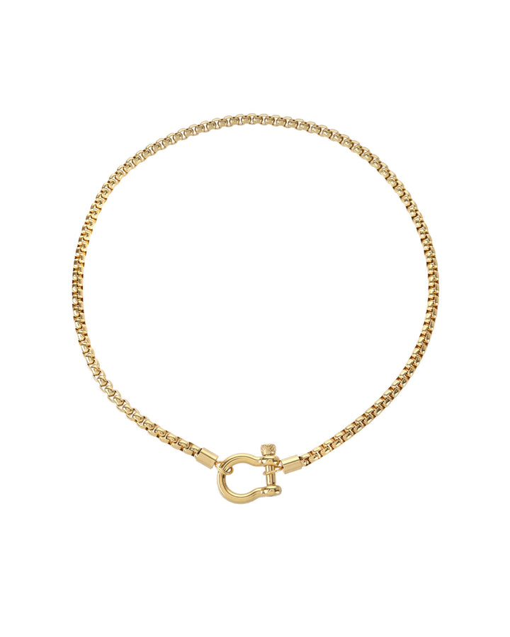 The Herradura Necklace, a gold chain necklace with a unique horseshoe-shaped clasp. |||Gold