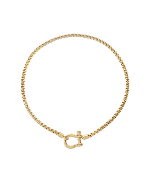 The Herradura Necklace, a gold chain necklace with a unique horseshoe-shaped clasp. |||Gold