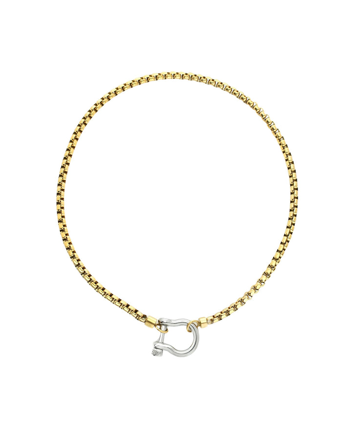 The Herradura Mix Necklace, a gold necklace featuring a box chain with a silver horseshoe clasp. |||Silver