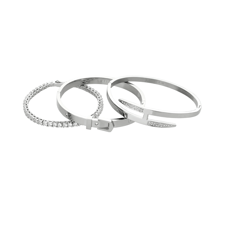 The **Core Stack**, a set of three sleek silver-tone bracelets, includes a sparkling stone bangle, a minimalist cuff, and a modern nail-inspired design, perfect for layering or wearing solo.