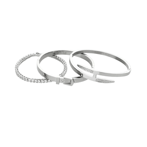 The **Core Stack**, a set of three sleek silver-tone bracelets, includes a sparkling stone bangle, a minimalist cuff, and a modern nail-inspired design, perfect for layering or wearing solo.