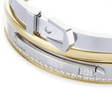 The BELTED BRACELET STACK, a stylish four-piece bangle set featuring a mix of gold and silver tones with intricate details like a buckle clasp and diamond accents. 