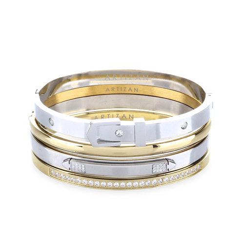 The BELTED BRACELET STACK, a stylish four-piece bangle set featuring a mix of gold and silver tones with intricate details like a buckle clasp and diamond accents. 