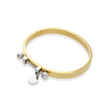 The Coin Bangle is a mixed-metal bracelet featuring a sleek gold band with silver-tone hardware, including a dangling coin charm and bold spherical accents. ||| MIX SILVER