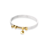 The Coin Bangle is a mixed-metal bracelet featuring a sleek silver band with gold-tone hardware, including a dangling coin charm and bold spherical accents. ||| MIX GOLD