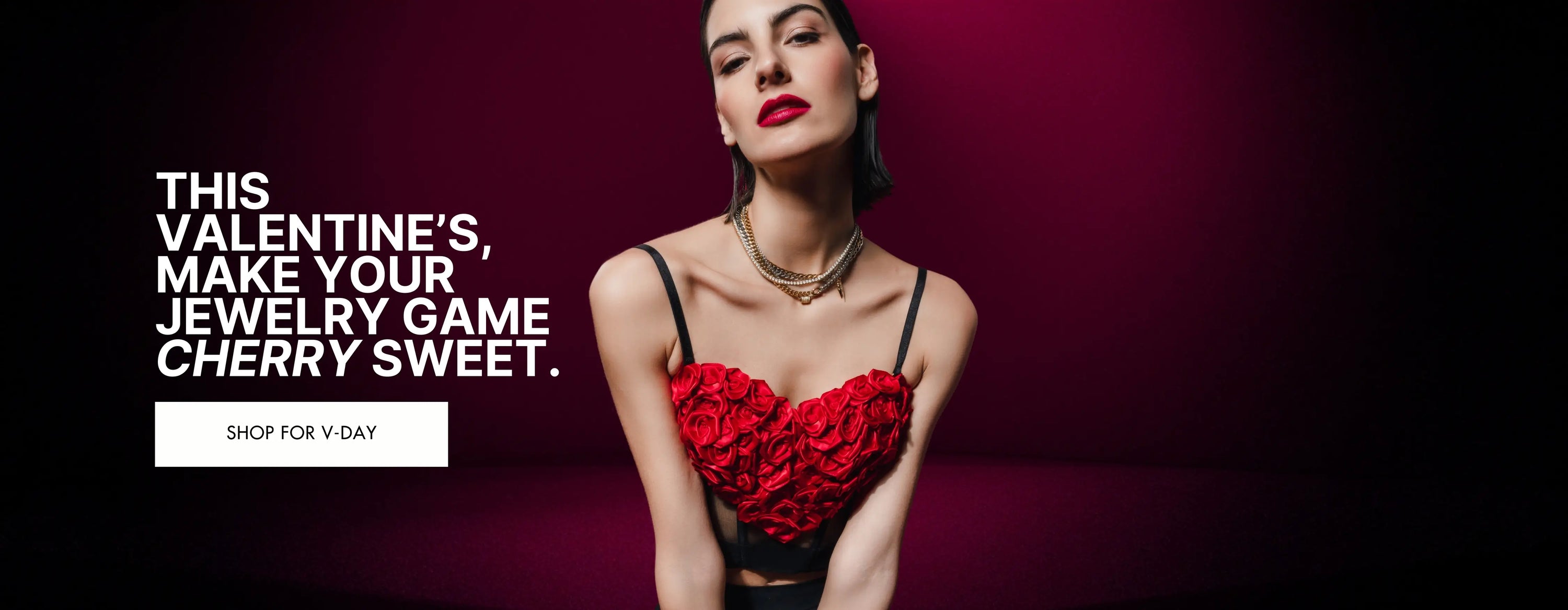 Model wearing layered gold necklaces and bracelets paired with a bold red rose-themed top. The text reads, "This Valentine's, make your jewelry game cherry sweet," promoting jewelry for Valentine’s Day with a call-to-action button: "Shop for V-Day."