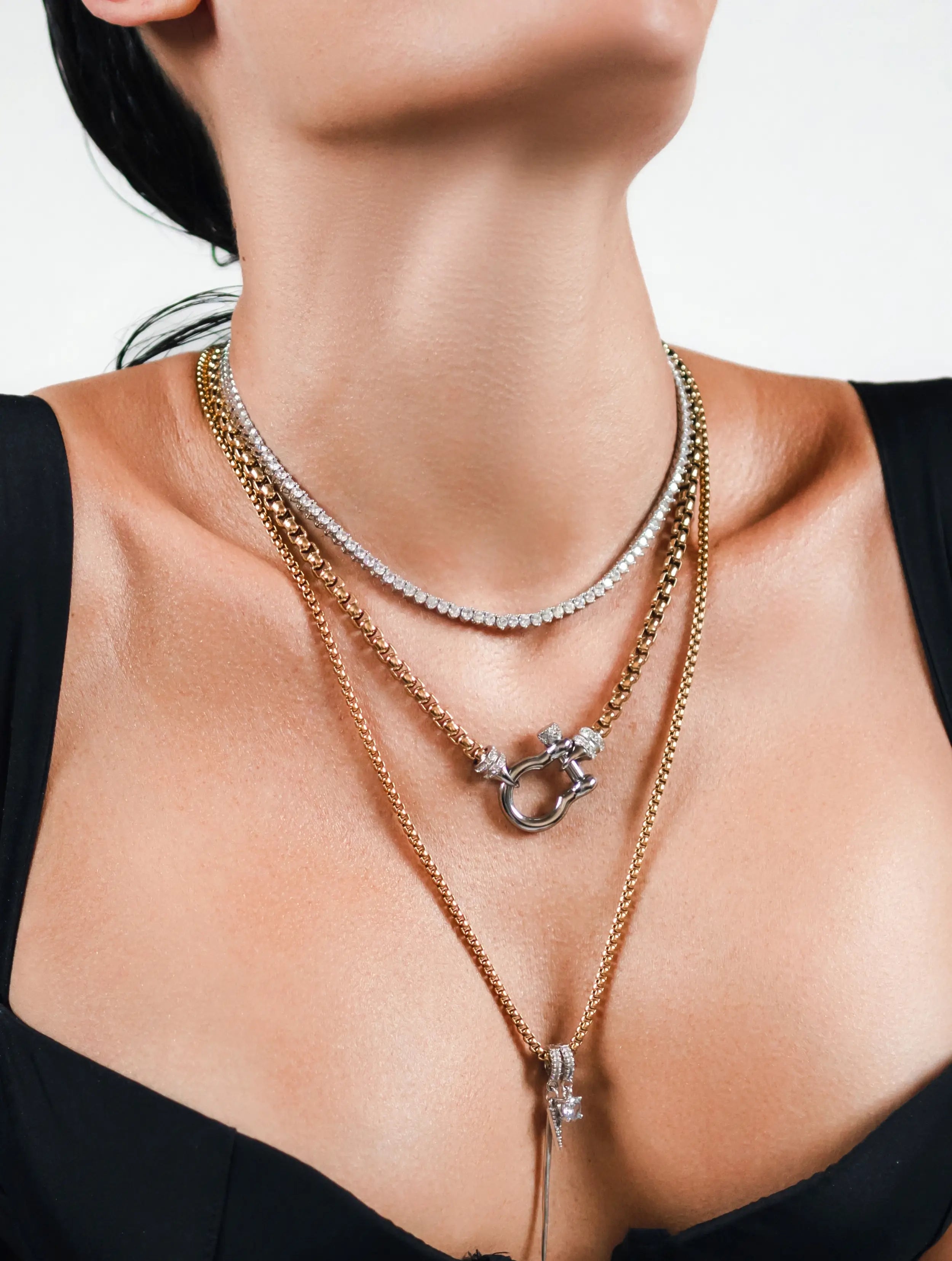 Model wearing the Herradura Signature Spiga Tennis Set, a luxurious layered necklace featuring mixed-metal chains, a tennis necklace, and signature charm details.