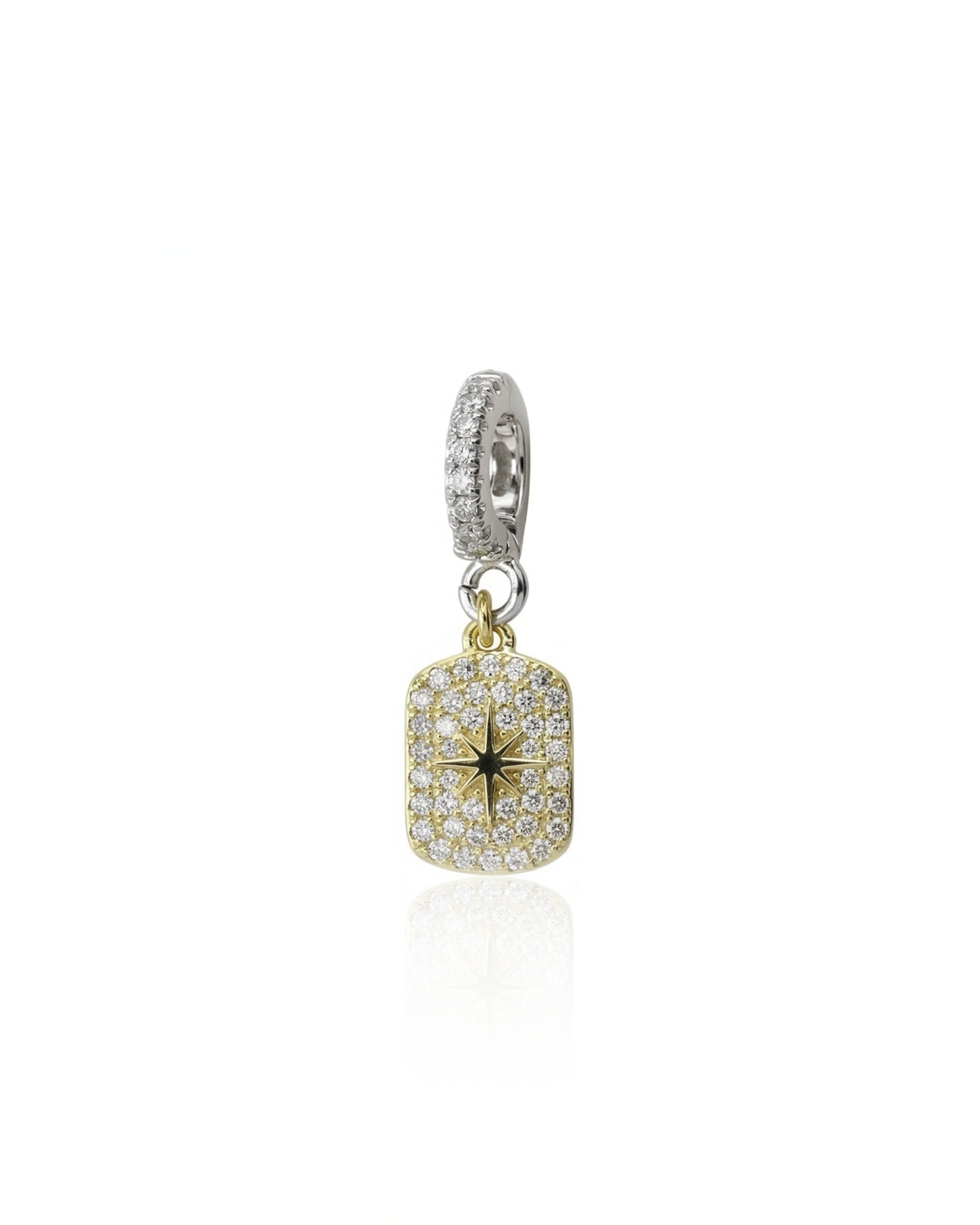 The Celestial Star Clip On Charm, a gold charm with a  star design accented with pave diamonds and a silver clip-on bale.