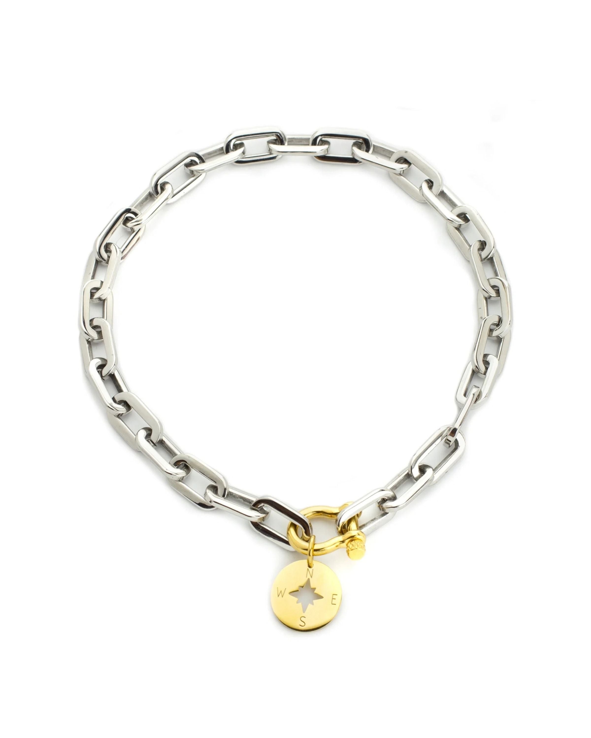 The Herradura Puerto Necklace, a silver necklace with a gold compass charm and a unique clasp.