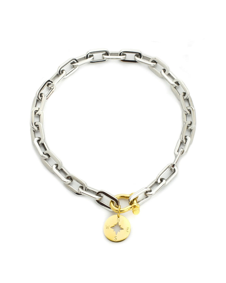 The Herradura Puerto Necklace, a silver necklace with a gold compass charm and a unique clasp.