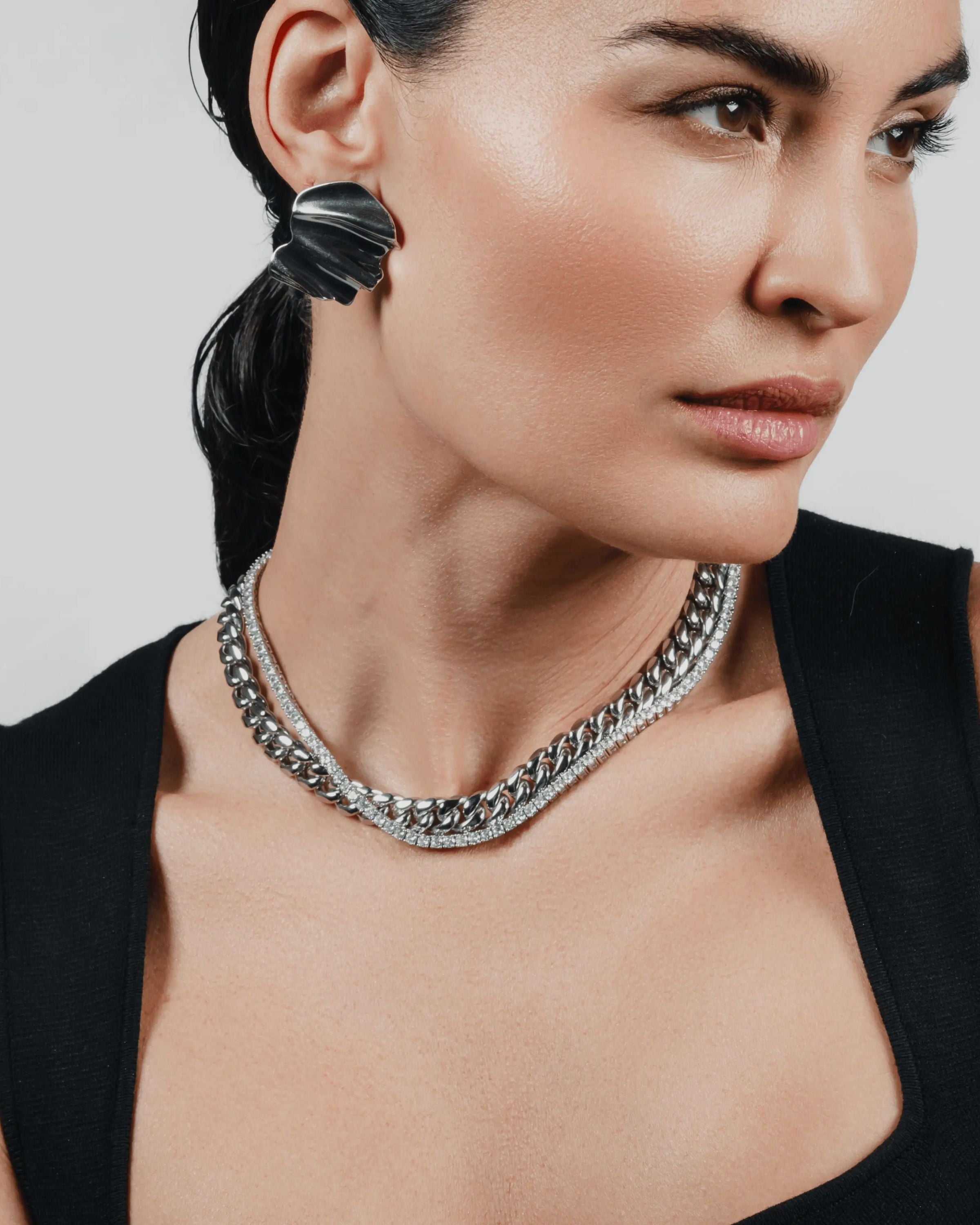 Two-piece layered necklace stack in silver, featuring a chunky curb chain and a tennis chain. ||| SILVER